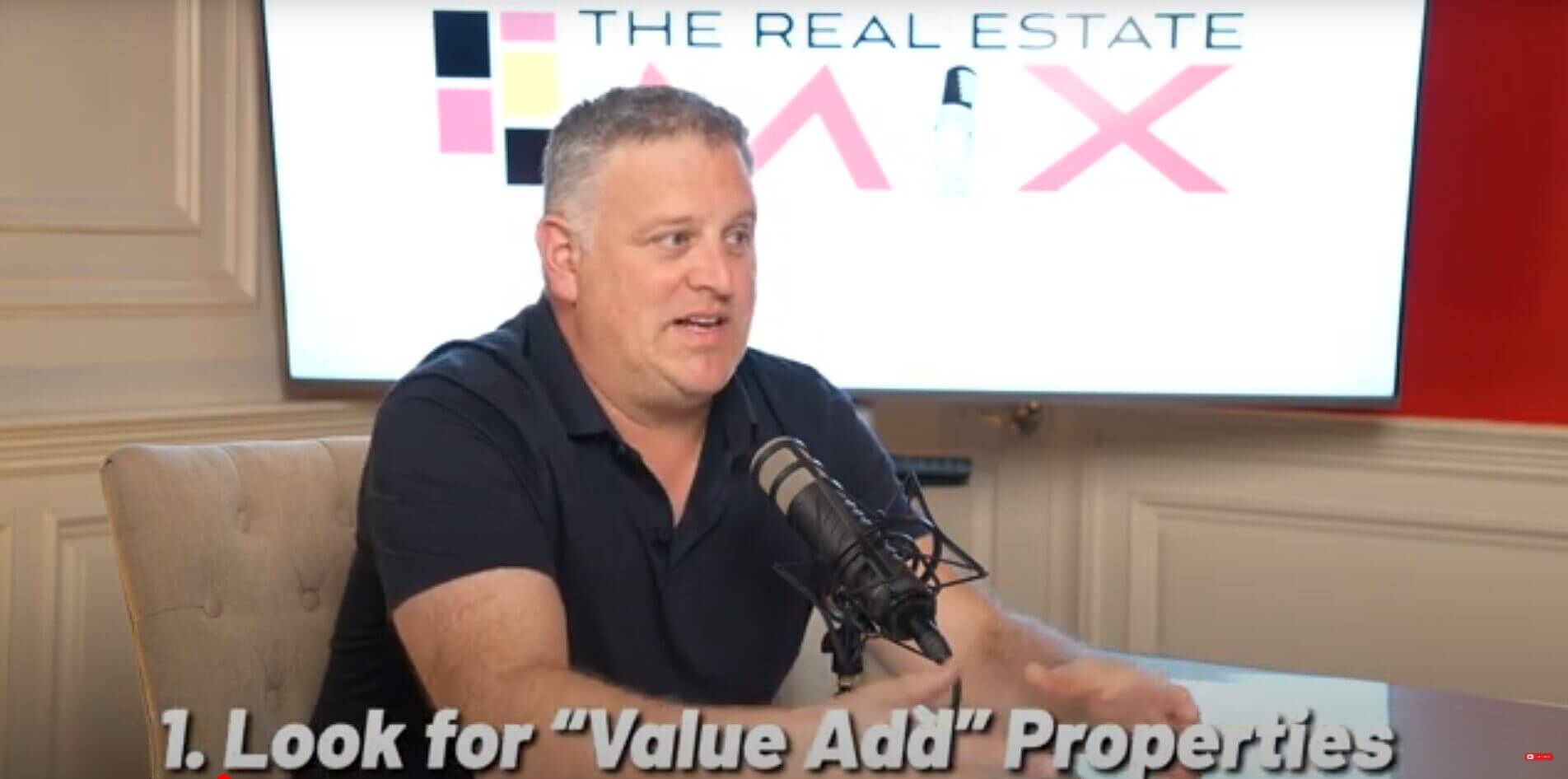 Podcast host discussing real estate strategies on "The Real Estate Mix" show about identifying value-add properties.